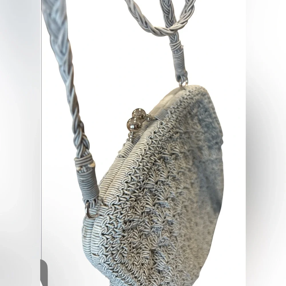crocheted evening bag with a metal kiss-lock closure and braided shoulder strap